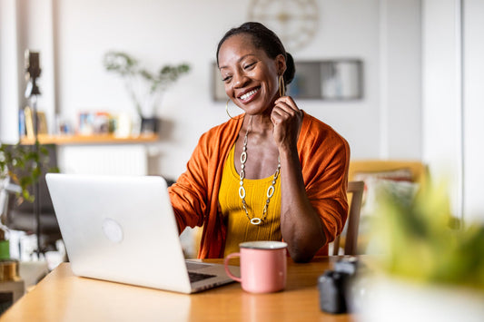 Entrepreneur happily working at her laptop